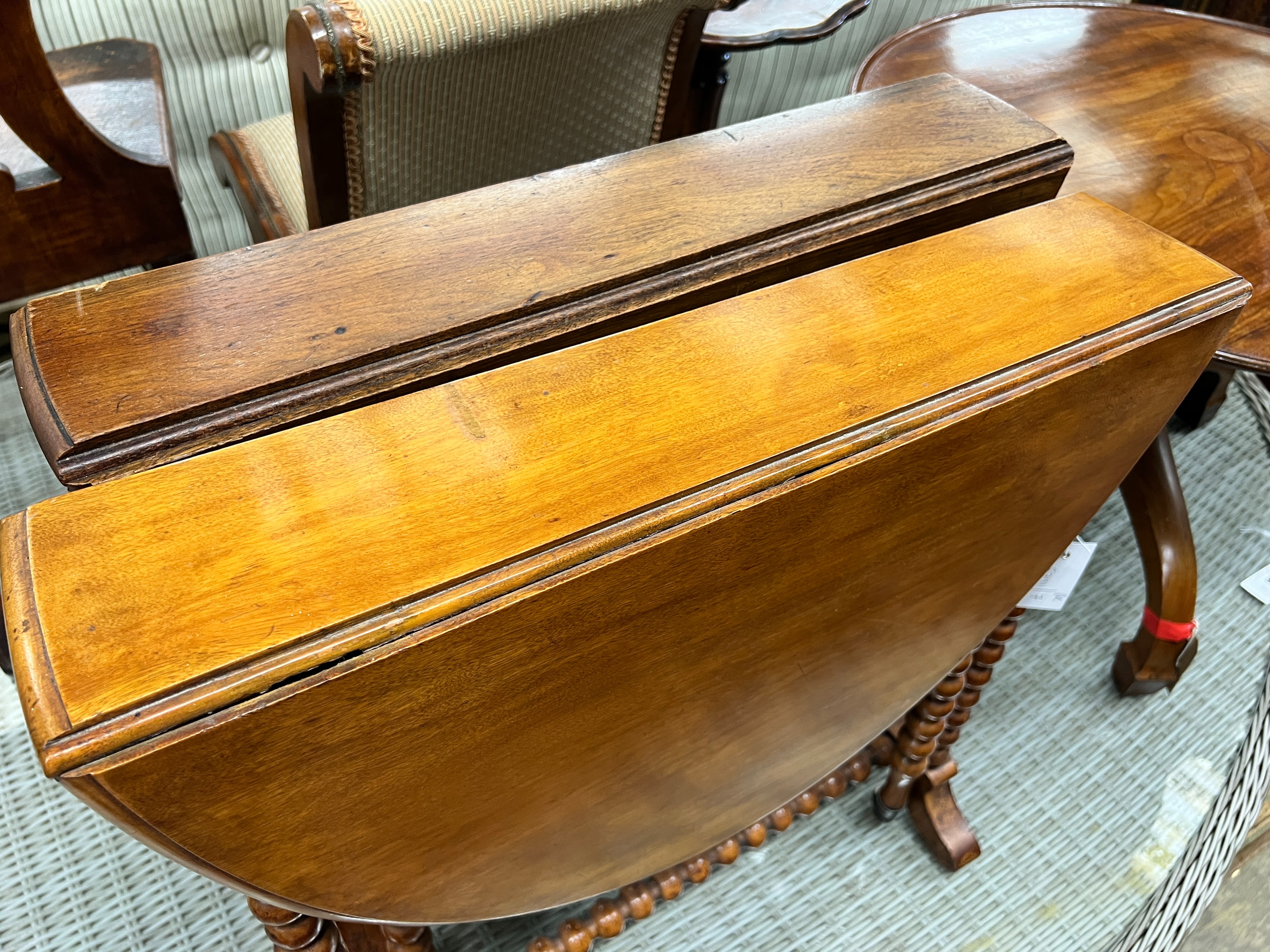 A near pair of Victorian mahogany bobbin turned Sutherland tables, width 60cm, depth 13cm, height 60cm